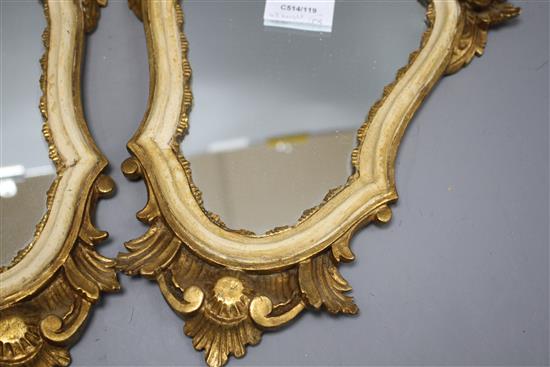 A pair of Italian giltwood cartouche shaped wall mirrors, width 25cm, height 43cm